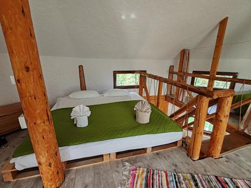 a bedroom with two bunk beds and a staircase at Cabana cu hamac in Prisaca Dornei