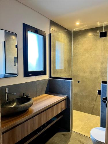 a bathroom with a sink and a glass shower at Finca Torcivia Luna in Vista Flores
