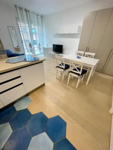 a kitchen and dining room with a table and chairs at Blu Mare Loft an elegant place just a few steps from the sea in Celle Ligure
