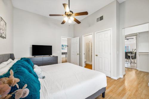 a white bedroom with a bed and a ceiling fan at Beautiful 1 BR Home Pool Bocce Court in Bermuda Dunes
