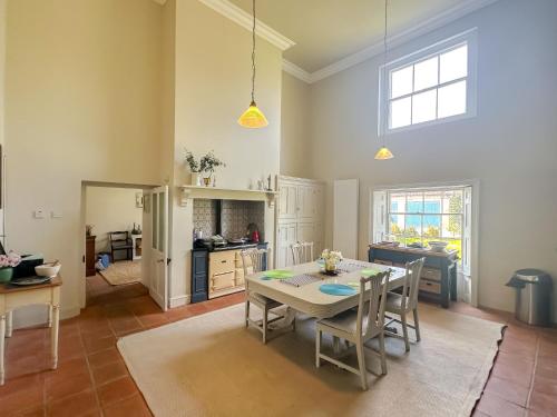 a kitchen and dining room with a table and chairs at Beautiful Georgian Country House - Norfolk in Dilham