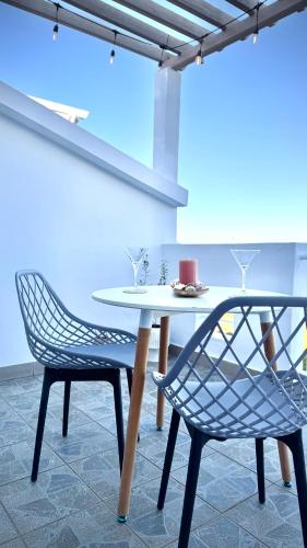 a white table and two chairs in a room at Zephyr House Ocean Breeze with Pool in Grand Gaube