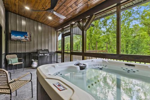 a jacuzzi tub in the middle of a room at Sleeps 24/ 4 Kitchens / 4 Hot Tubs / 4 Firepits in Slade