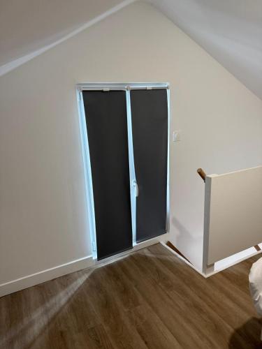 a sliding glass door in a white room at Residence du bois 2 in Mitry-Mory