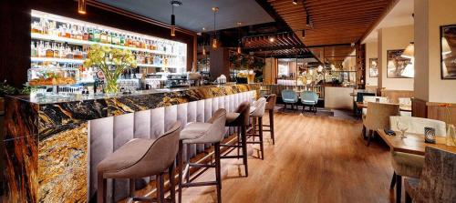 a bar with a row of stools at a restaurant at B&B HOTEL RZESZÓW CENTRUM in Rzeszów
