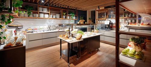 a large kitchen with a counter with food on it at B&B HOTEL RZESZÓW CENTRUM in Rzeszów