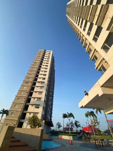 a tall building with a pool in front of it at Stylish 1bedroom apartment at Muntinlupa in Manila
