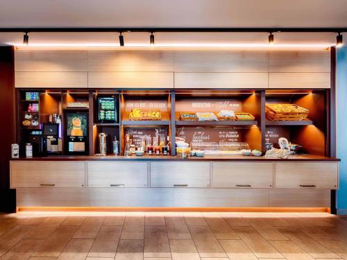 a fast food restaurant with a counter with food at B&B Hotel Paderborn in Paderborn