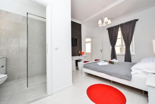 a bedroom with a bed and a bathroom with a shower at Rooms Urban design in Zadar
