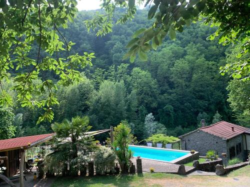 a resort with a swimming pool in the mountains at Magic Mill Castagnetoli in Mulazzo