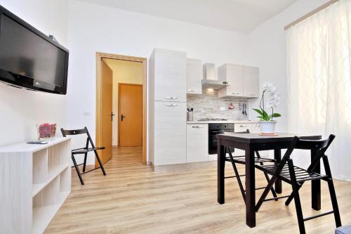 a kitchen and dining room with a table and chairs at Holiday rental San Lorenzo district in Rome