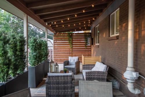 a patio with chairs and a table and lights at Home With Sunset Patio, Fenced Backyard, And Quick Access To Denver - Gray Street in Arvada