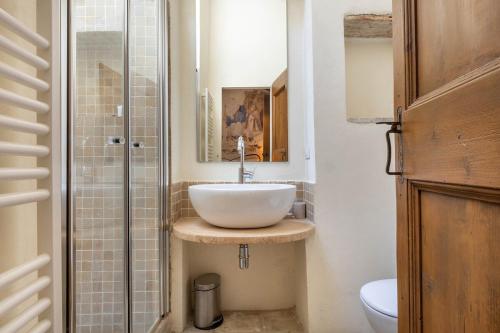 a bathroom with a sink and a toilet at La Capella in Gubbio