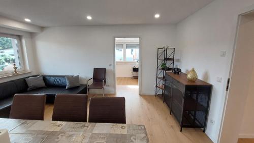 a living room with a couch and a table at Fewo Gerda im schönen Odw in Mörlenbach