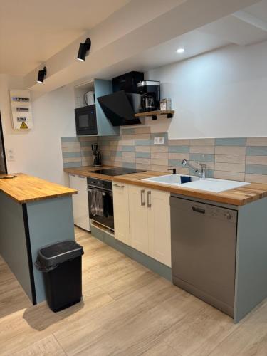 a kitchen with a sink and a counter top at appartement 4 personnes yvetot maurienne express in Saint-Jean-de-Maurienne