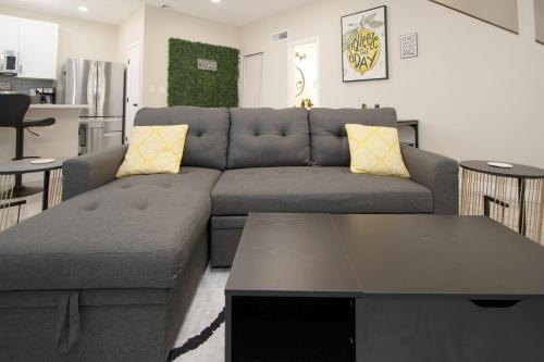 a living room with a couch and a table at Stylish Lemon 2BR and 3BA Townhouse in Tempe