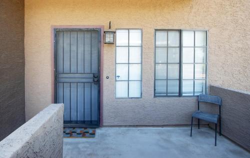 a door and a chair in front of a building at Stylish Lemon 2BR and 3BA Townhouse in Tempe