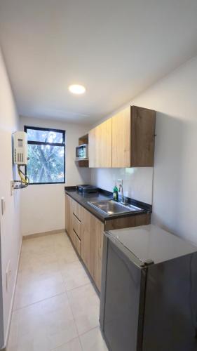 a kitchen with a sink and a counter top at Edificio Fenicia Lofts Laureles in Medellín