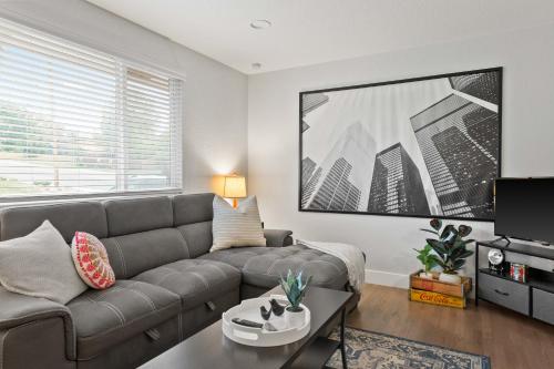 a living room with a couch and a table at Private 2BR Retreat Near Denver - Gray St in Arvada