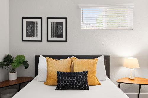 a bedroom with a bed with three pictures on the wall at Private 2BR Retreat Near Denver - Gray St in Arvada