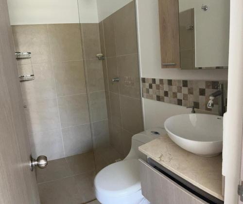 a bathroom with a toilet and a sink at Apartasol vacacional in Santa Fe de Antioquia