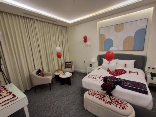 a hotel room with a bed with red balloons on it at بنزرت للشقق المخدومة in Al Hofuf