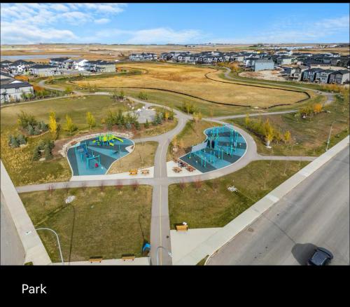 an aerial view of a park next to a road at Brand new suite with parking pad at the back in Calgary