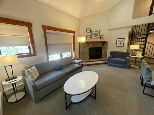 a living room with a couch and a table at Wedgewood Lodge in Breckenridge