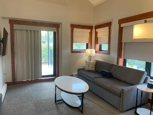 a living room with a couch and a table at Wedgewood Lodge in Breckenridge