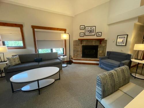 a living room with a couch and a fireplace at Wedgewood Lodge in Breckenridge