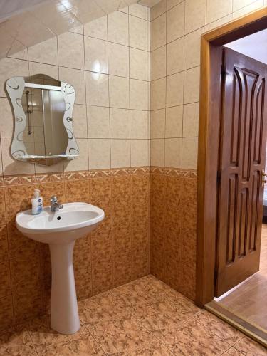 a bathroom with a sink and a mirror at Hotel Мукачево in Mukacheve