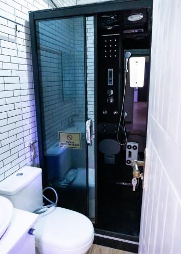 a bathroom with a shower with a toilet in it at Pemium RiverSide Apartments Ile Ife Nigeria in Ile-Ife