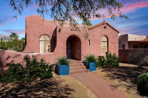 a pink house with a tree in front of it at Historic 3BD 2BA Tucson Bungalow, Steps to UofA in Tucson