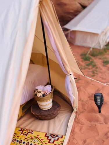 a tent with a basket of flowers in it at The Legacy of Wadi Rum in Wadi Rum