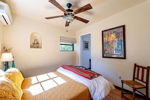 a bedroom with a bed and a ceiling fan at Historic 3BD 2BA Tucson Bungalow, Steps to UofA in Tucson