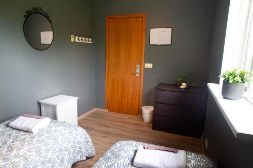 a bedroom with a bed and a wooden door at Efra Sel Hostel in Fludir