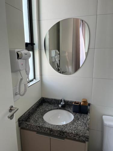 un bagno con lavandino e specchio di Flat em Boa Viagem a Recife