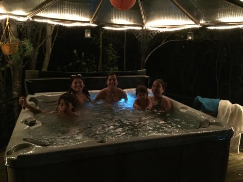 a group of people in a bath tub at Cabañas Natural Park Lodge Pucón in Pucón