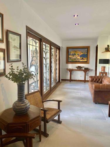 a living room with a couch and a vase on a table at Casa Bali Costa Brava in Palafrugell