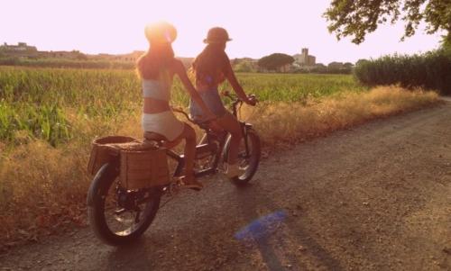 two women riding bikes on a dirt road at Casa Bali Costa Brava in Palafrugell