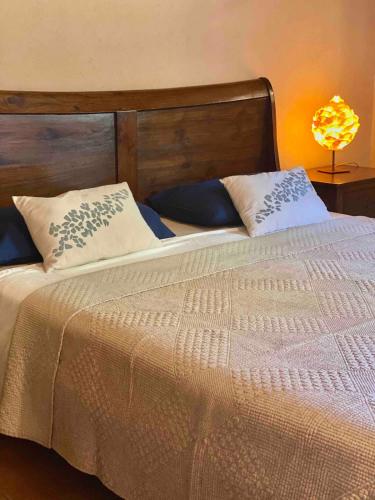 a bed with two pillows on top of it at Casa Bali Costa Brava in Palafrugell