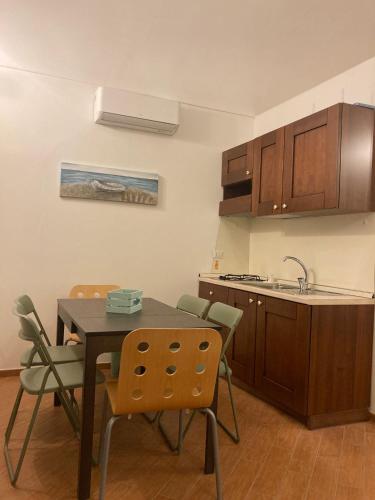a kitchen with a table and chairs and a sink at Lidia's House Bacoli in Bacoli