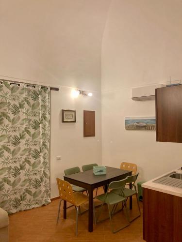 a dining room with a table and chairs at Lidia's House Bacoli in Bacoli