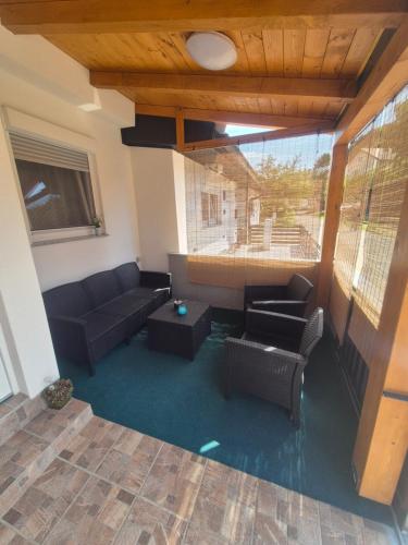 a living room with a couch and a table at Apartment Lela - self check-in and check-out in Otočac