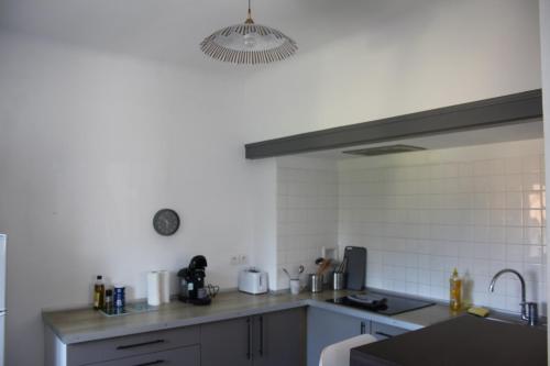 a kitchen with a sink and a counter top at Le Nid - 2 Bedrooms - Myra Conciergerie in Gan