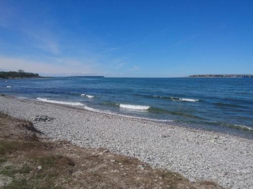 a rocky beach with the ocean in the background at 4 star holiday home in Klintehamn in Klintehamn
