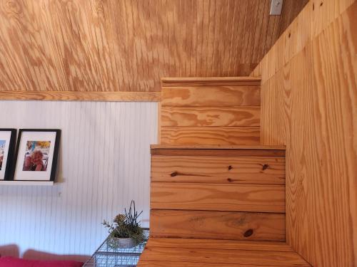 a room with a wooden wall with a dresser at Barn Bungalow in Bandera