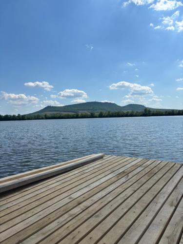 a wooden dock sitting on top of a body of water at Vinný sklep s apartmány u Kvěchů in Bavory