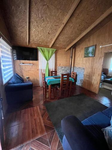 a living room with a table and a couch at Cabañas 4 PIA in Puerto Tranquilo