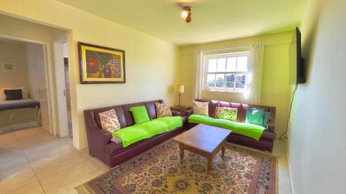 a living room with a couch and a table at Pousada Hortelã Village in Campos do Jordão
